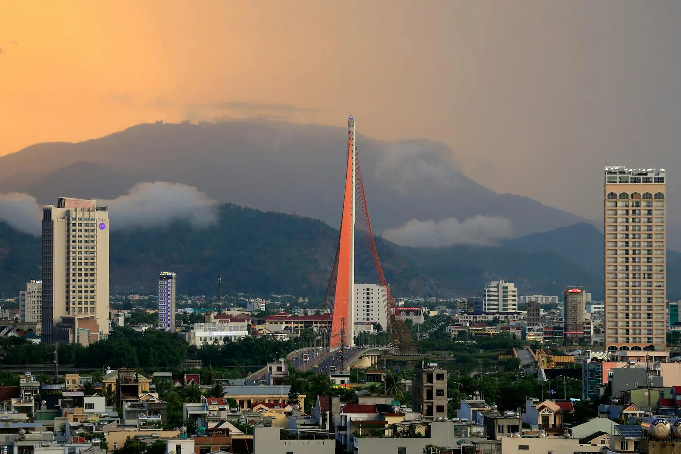 Da Nang cityscape with the Han River Bridge at sunset.